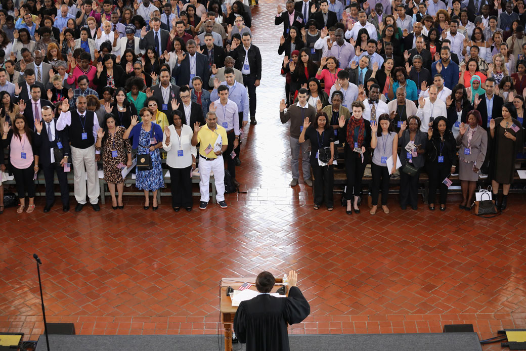 Immigrants take the oath of citizenship to the United States in the Great Hall of Ellis Island on September 16, 2016, in New York City.