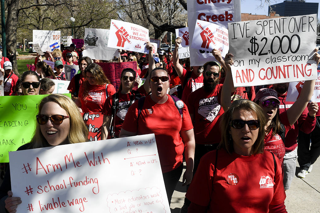 Teachers don red and march around the capitol grounds en masse during a teachers rally for more educational funding at the Colorado State Capitol, April 27, 2018. (Getty/The Denver Post/AAron Ontiveroz)