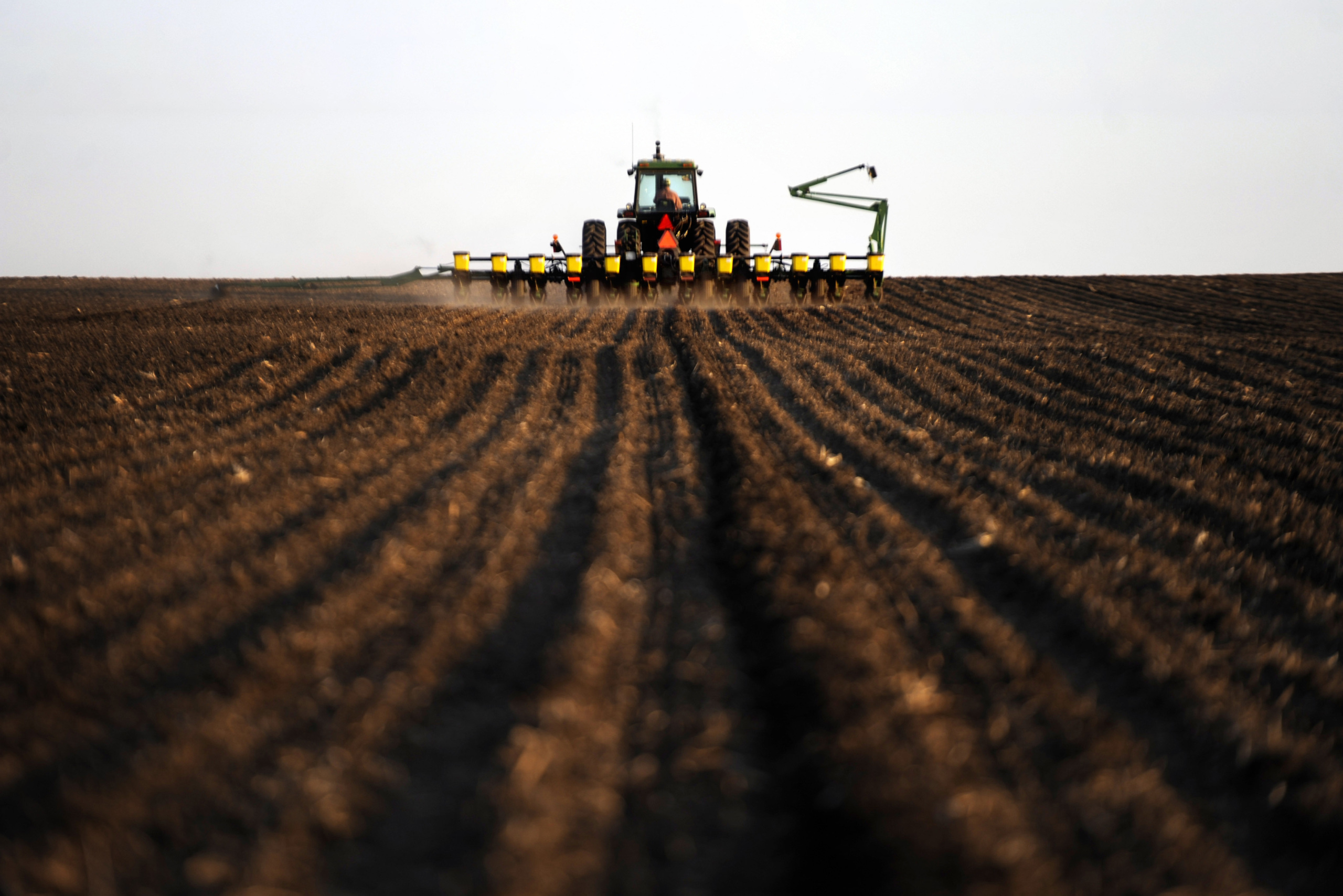 A crop farmer and recipient of USDA farm subsidies works to prepare equipment for evening planting of corn in Hull, Sioux County, Iowa, April 2011. (Getty/Melina Mara)