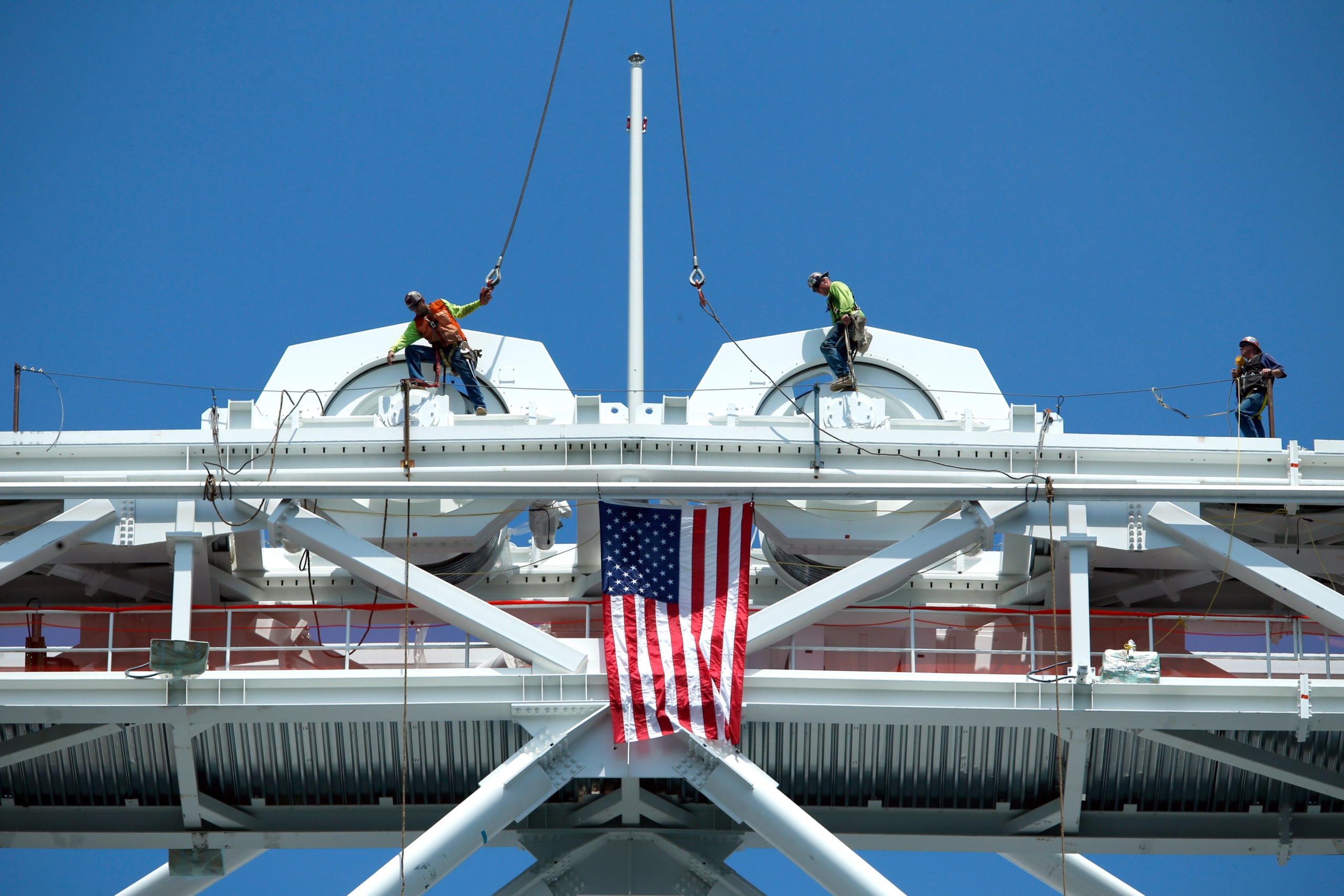 Construction workers install the final piece of steel for the roof structure of Arthur Ashe Stadium, June 2015. (Getty/Kena Betancur)