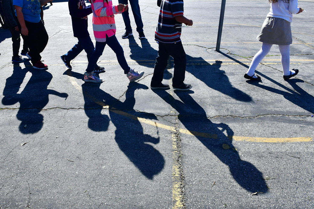 Children at an elementary school in Pacoima, California, walk across the schoolyard, February 2019. (Getty/Frederic J. Brown/AFP)