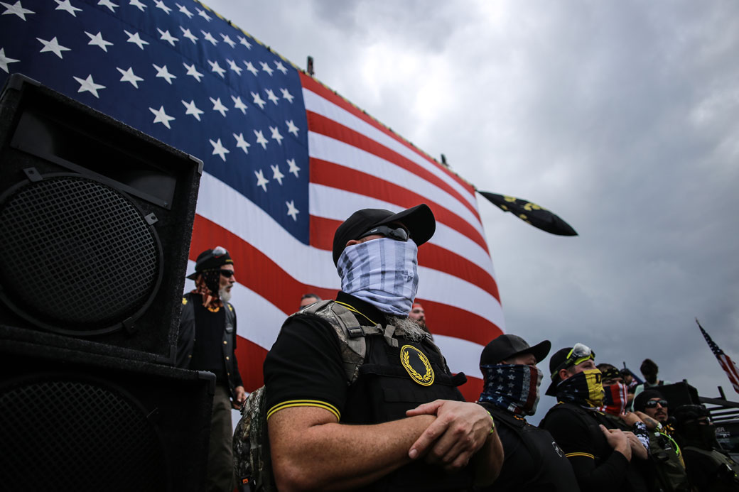 A member of the Proud Boys guards the front stage during a rally in Portland, Oregon, on September 26, 2020. (Getty/SOPA Images/LightRocket/Stanton Sharpe)