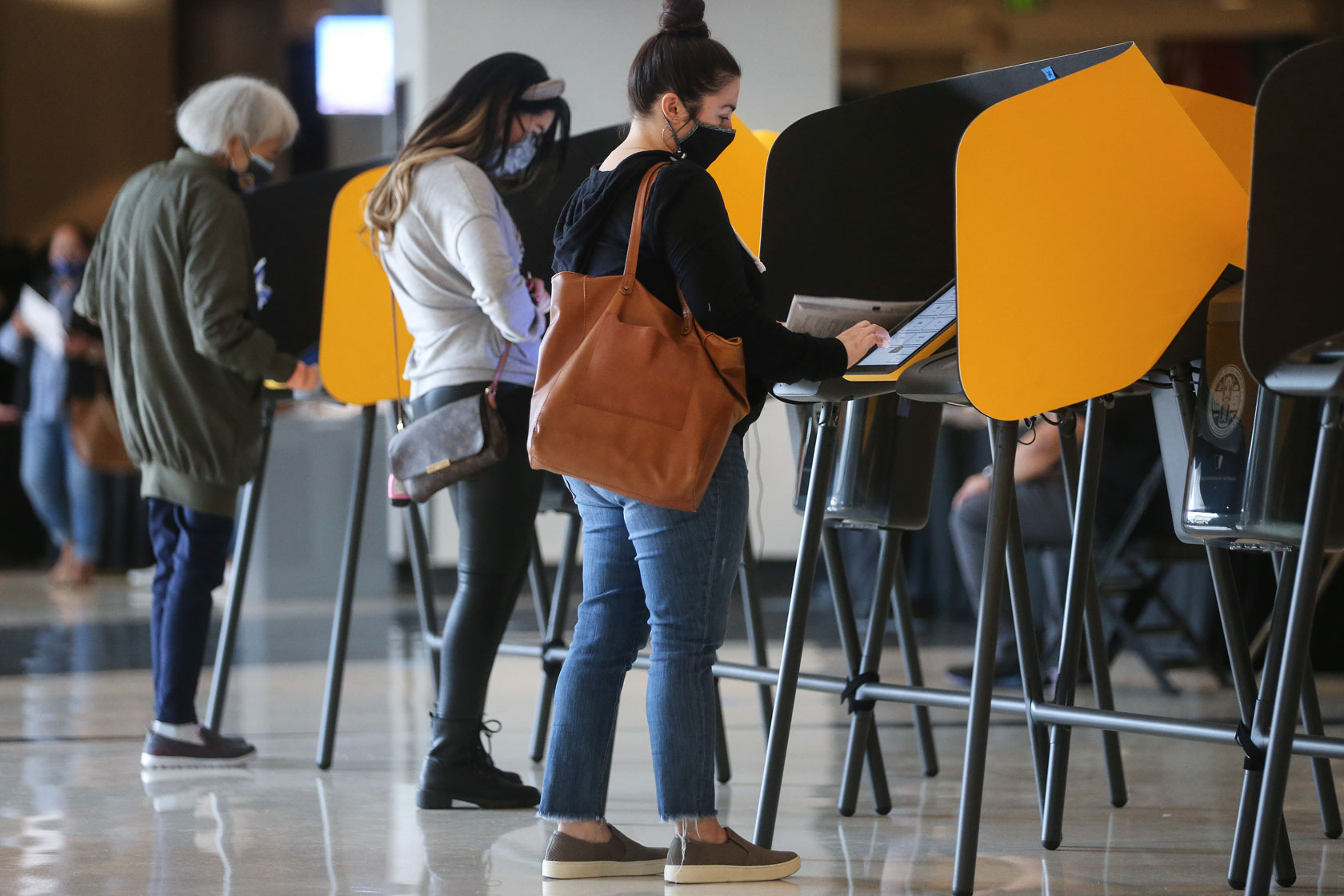 Voters mark their ballots at a voting center in Los Angeles on October 25, 2020.
