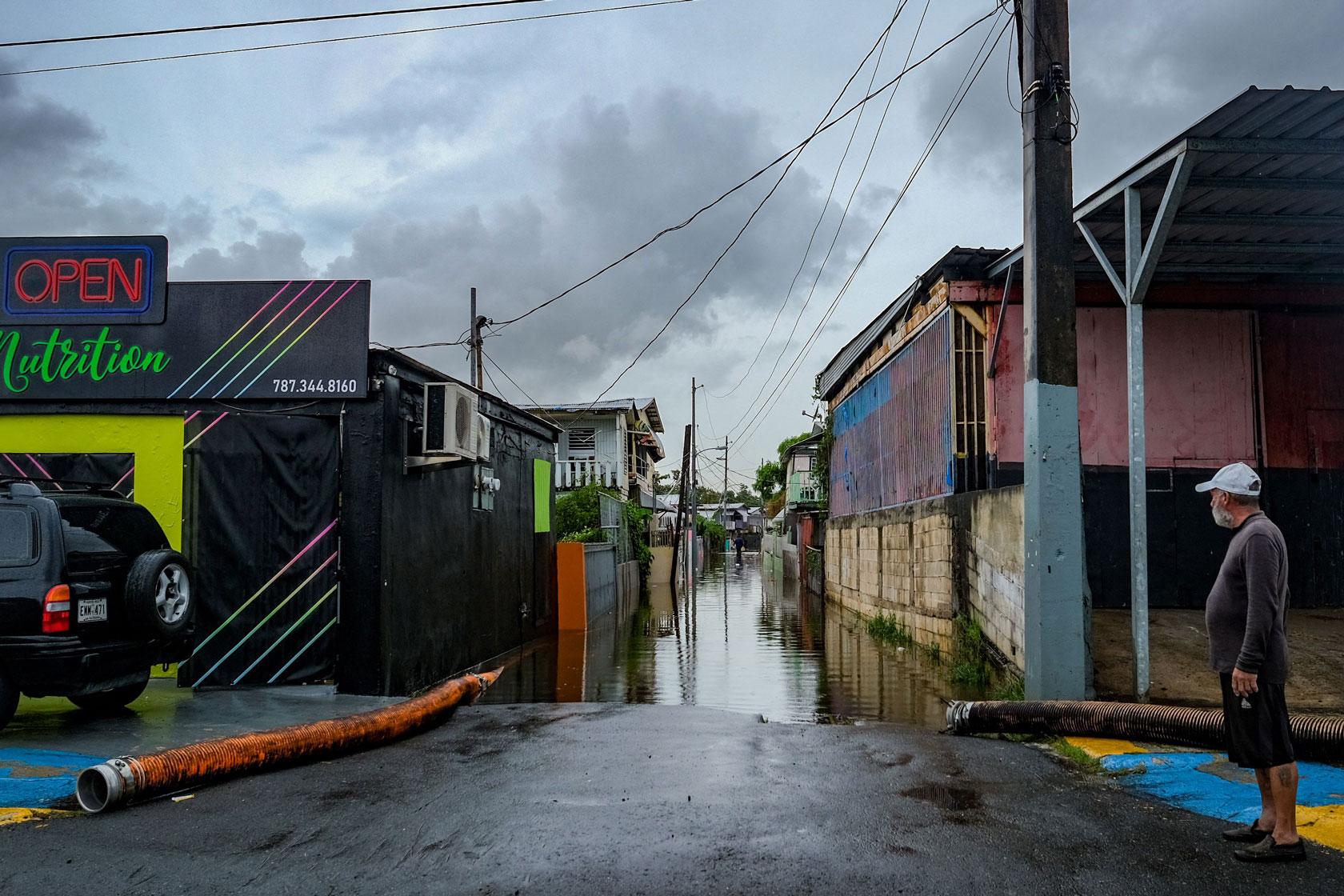 A man looks at a flooded street in the Juana Matos neighborhood of Cataño, Puerto Rico.