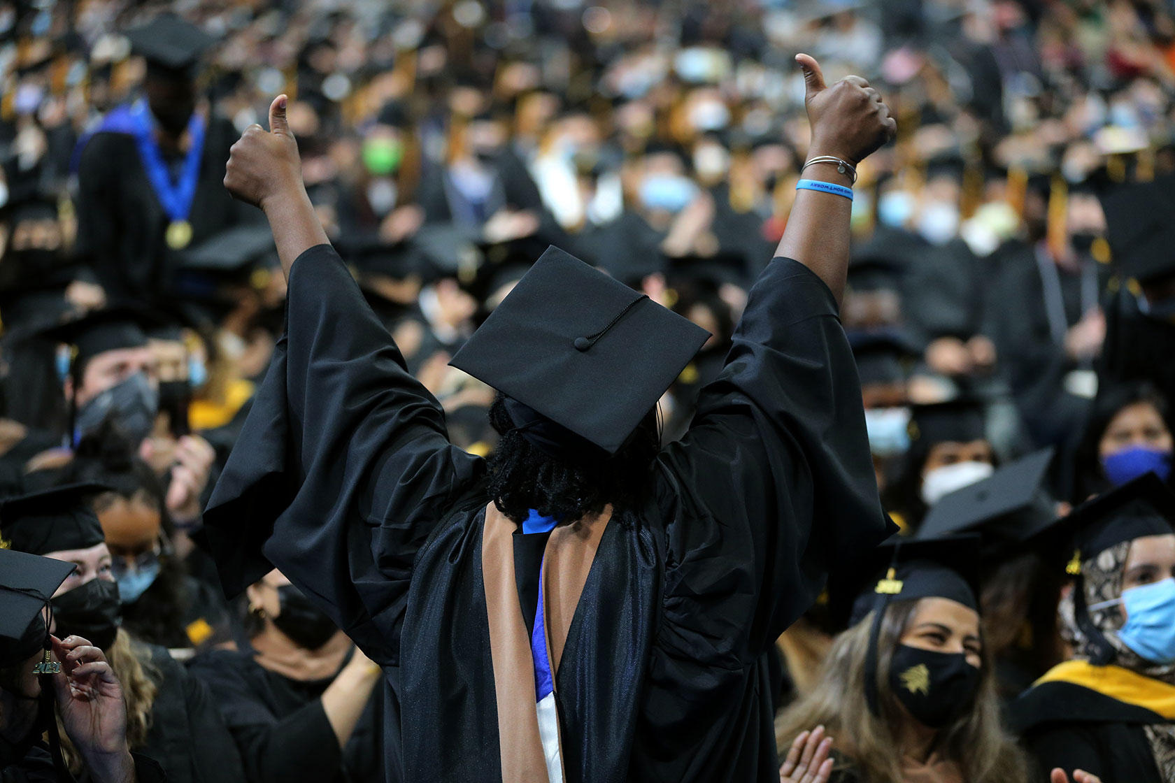 A graduating student celebrates during the University of Massachusetts Boston commencement ceremony.